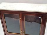a marble top cabinet with two doors and a marble top