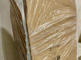 a stack of cardboard sitting on the floor next to a wall