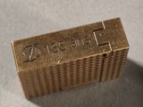 an image of a close up of a metal stamp on a table