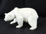 a white bear figurine on a black background