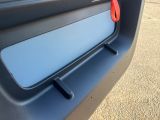 a close up of a car door handle with a red handle