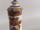 a white vase with a blue and yellow design on it