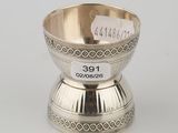 a silver bowl on a stand with a label on it