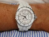 a person wearing a white watch on their wrist