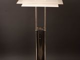 a white table lamp with a metal base on a wooden surface