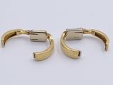 two pairs of gold plated cuff earrings on a white surface