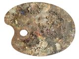a paint palette with a hole in it on a white surface