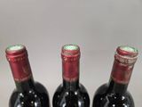three bottles of wine sitting next to each other on a table