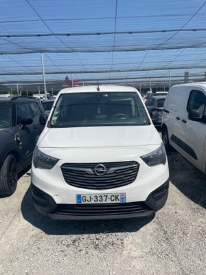 a white van parked in a parking lot next to other cars