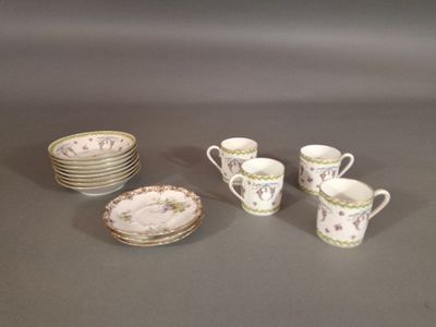 a lot of cups and saucers sitting on a table
