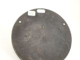 a metal plate with holes on it on a white surface