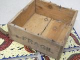 a wooden box with a pair of scissors in it