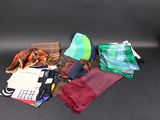 many different types of ties laid out on a black surface