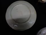 a white plate sitting on top of a black table