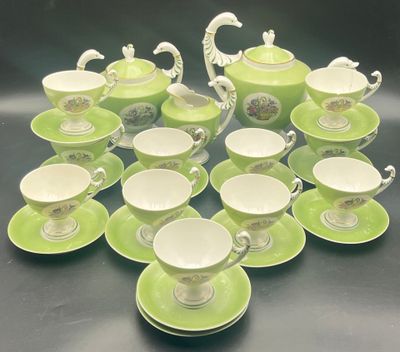 many cups and saucers sitting on a table