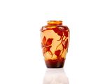 a vase with a bird design on it on a white surface