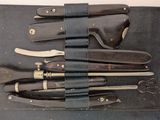 a leather case with a bunch of knives inside of it