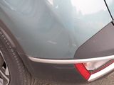 a close up of a car ' s rear end with a cat sitting on it