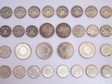 an image of a collection of silver coins on a white surface