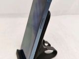 a cell phone that is on a stand on a table