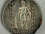 a close up of a silver coin with an image of a man on a horse
