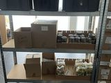 a shelf with boxes and boxes on it in a room