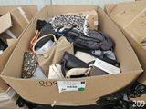 a cardboard box full of bags and purses in it