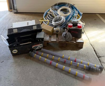 a pile of electrical equipment sitting on the floor next to a garage door
