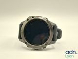 a close up of a smart watch on a white surface