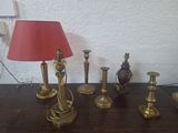 a table with a lamp, a lamp shade, and other items on it