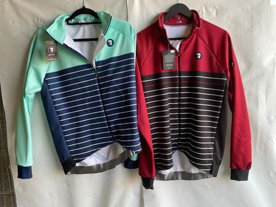 two men ' s jackets hanging on a hanger on a wall