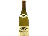 the bottle of white wine is sitting on a white surface