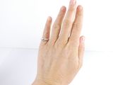 a woman ' s hand with a ring on it ' s finger