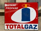 a red and white sign with a blue bottle on it