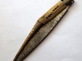 a small knife that is laying on a white surface
