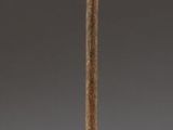 statue of a woman on a pole with a bird on it