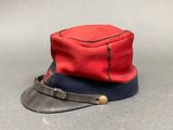 an image of a red and black hat on a gray surface