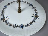 a cake stand with two plates on top of it