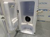 a white toilet that is open with the door open
