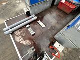a machine that is sitting on the ground next to a gas pump