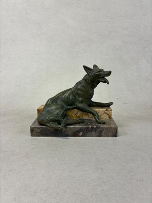 statue of a dog on a rock on a white background