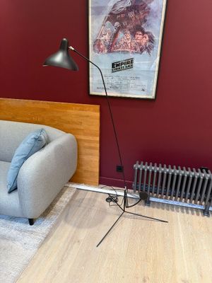 a couch and a chair in a room with a radiator