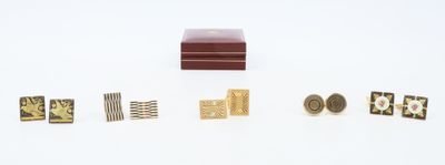 a small wooden box with several different pieces of jewelry on it