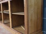 a large wooden cabinet with shelves in the corner of the room