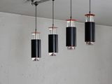 five lights hanging from the ceiling in a room