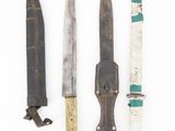 four different types of knives are lined up on a white surface