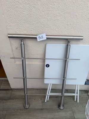 a white toilet sitting next to a metal rail