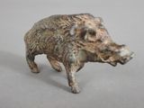 a small figurine of a boar on a table
