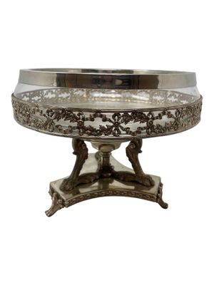 an antique silver plate with a stand on a white background
