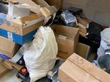 a pile of boxes and other items in a garage